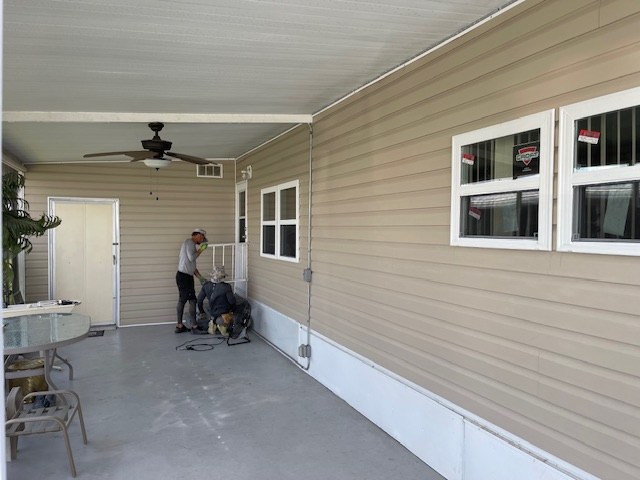 Replacement windows and siding on a covered mobile-home patio
